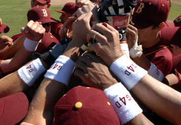 During a huddle before a game against Cabrillo High School at Blair Field, members of the Long Beach Wilson High School baseball team wear wrist bands with the number 4 and initials GD for former teammate Gary DeVercelly, 18, who died Friday March 30th after excessive drinking at a fraternity house in Trenton, New Jersey. The Mercer County Prosecutor's office is investigating his death as a possible hazing incident. (Stephen Carr / Press-Telegram)